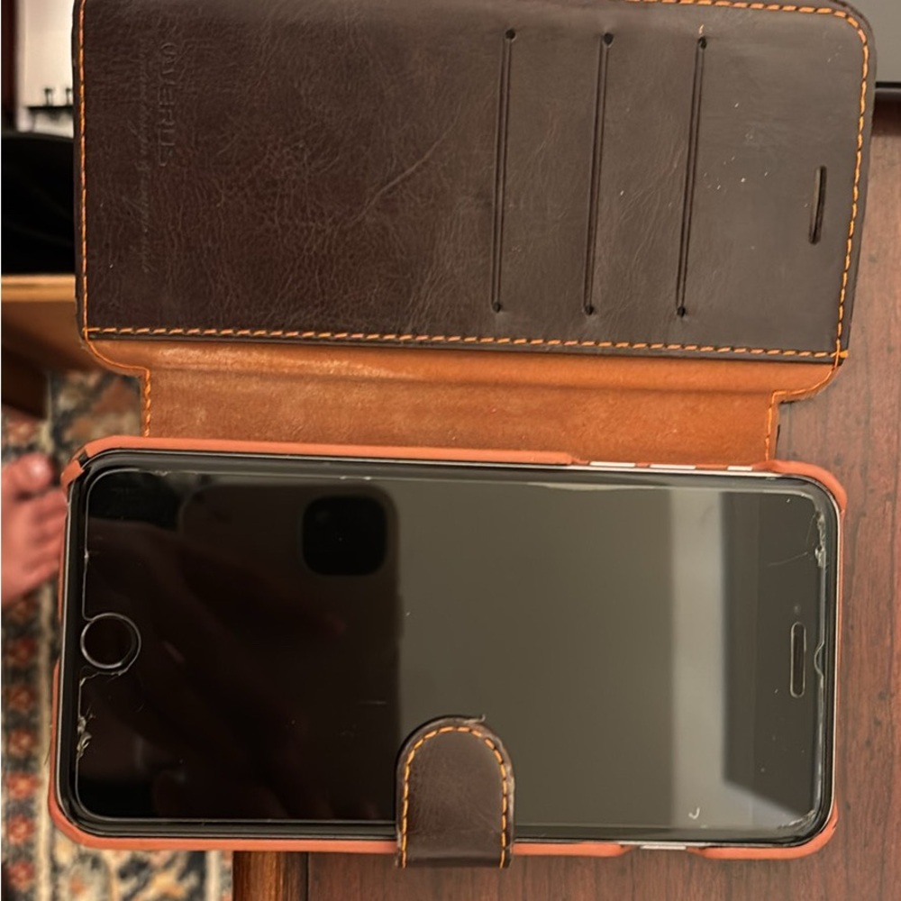 iPhone 6s with multiple cases and requires SIM card from AT&T